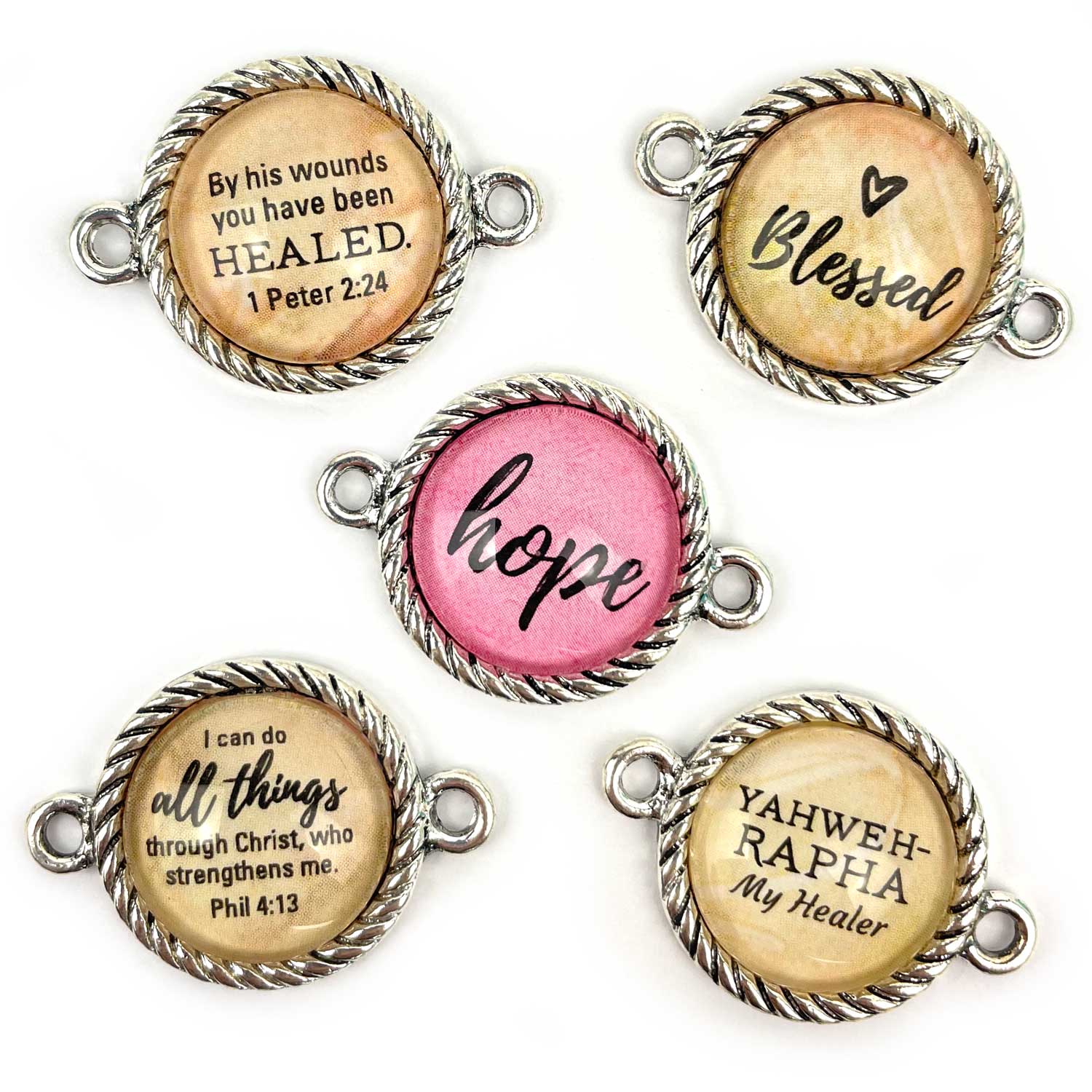 Antique silver-plated twist-edge bezels have a 16mm glass cabochon and two round bails. Total diameter is 20mm, horizontal (sides) orientation.