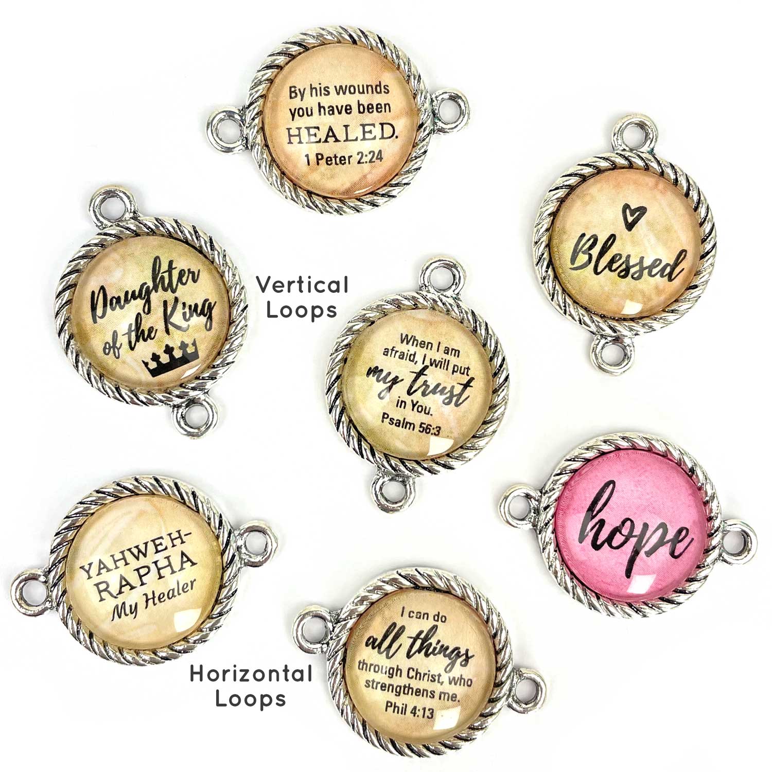 Antique silver-plated twist-edge bezels have a 16mm glass cabochon and two round bails. Total diameter is 20mm. Choose either horizontal (sides) or vertical (top and bottom) orientation.