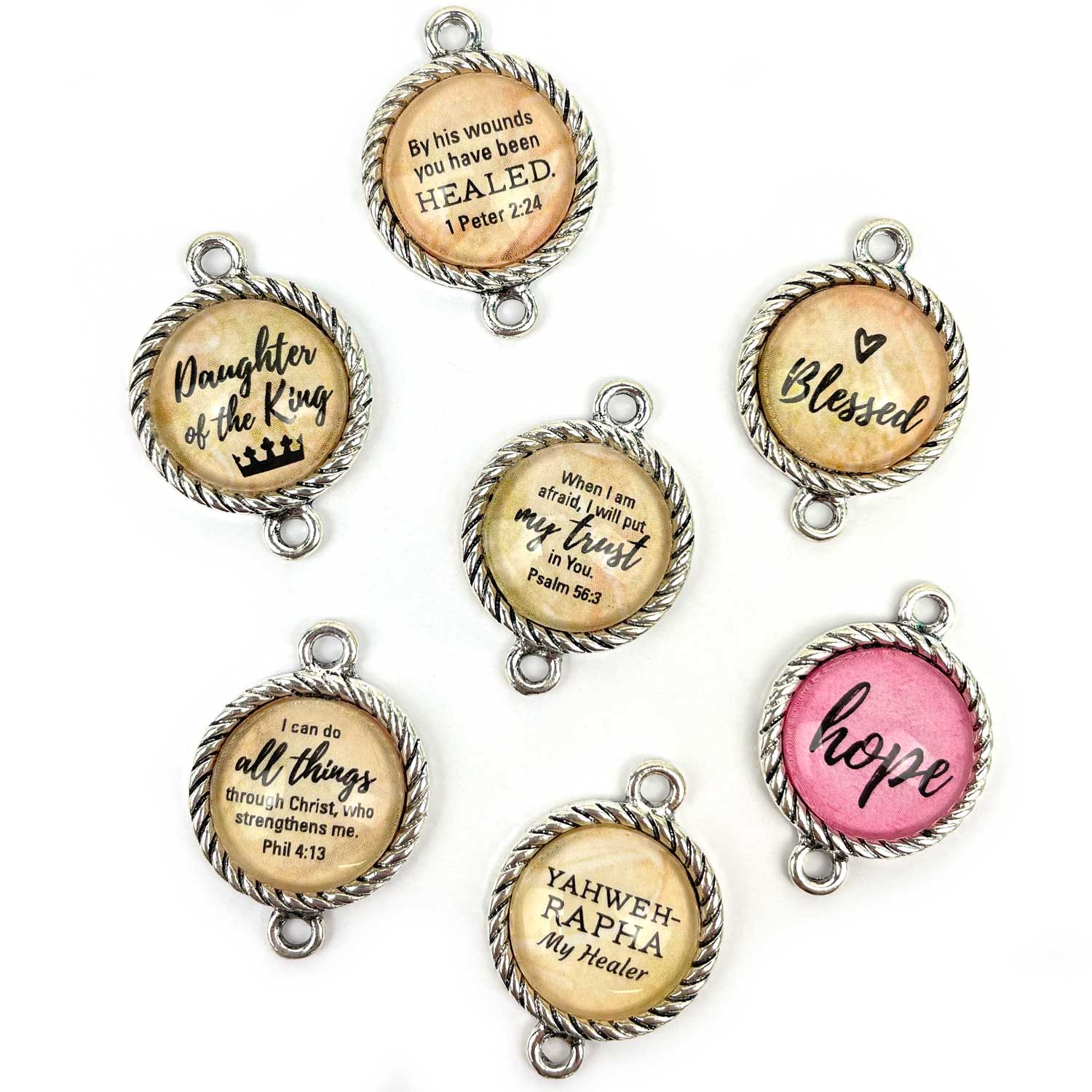 Antique silver-plated twist-edge bezels have a 16mm glass cabochon and two round bails. Total diameter is 20mm, vertical (top and bottom) orientation.