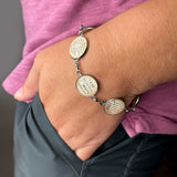ScriptCharms 6-charm stainless steel bracelet on wrist