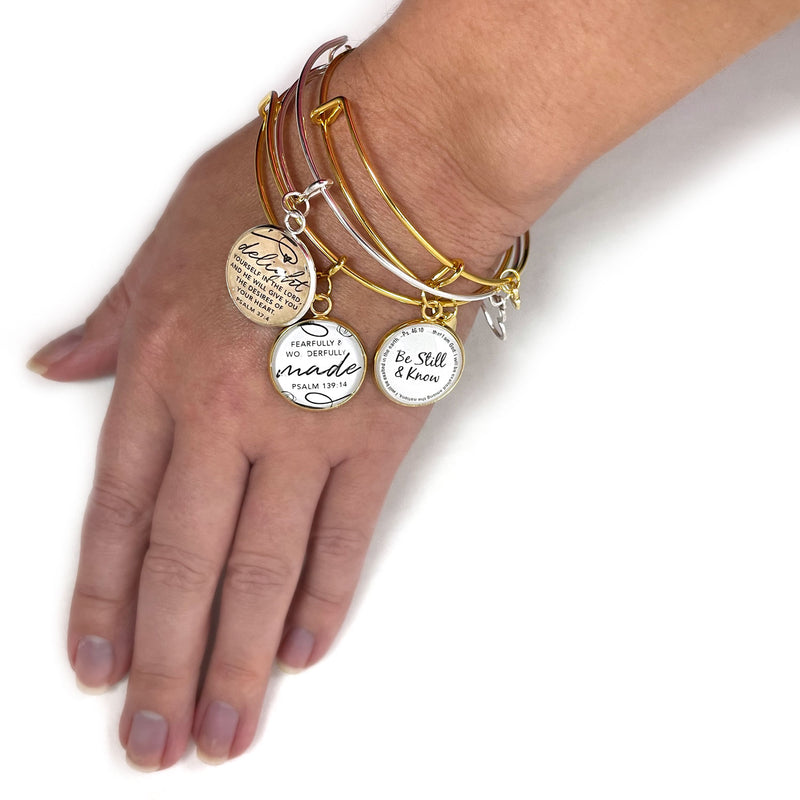 Charm bangle bracelets on wrist